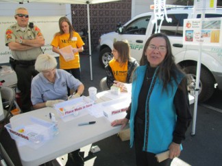 ETUSD Trustee Anita Anderson drops off her expired medications at the MCCASA Take Back booth at Frazier Park Market. [photo by Gary Meyer]