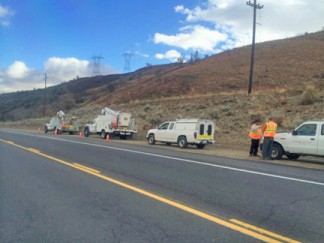 AT&T trucks and repair crew members at the scene where the telephone line was severed. [photo by Gary Meyer]