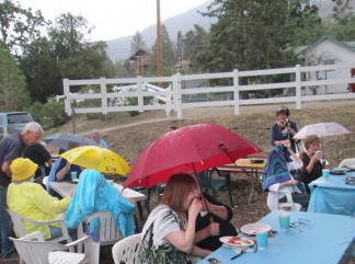 Picnic-goers at Ridge Route Museum cheered as the rain began falling around 5:40 p.m.—then ran for their umbrellas. [photo by Gary Meyer]