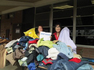 Angels of warmth—(l-r) Pam McCain and Mitch Wood were delighted to give out several hundred coats. [photo by Gary Meyer]