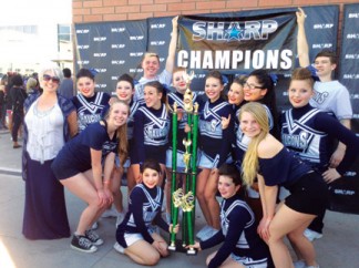 The Frazier Mountain High School Falcon Cheerleading Team won the Sharp Southern California Cheer Team Championship. In the back are Co-Captain Cody Johnson and Michael Green. In the middle row are  (l-r)Coach Lisa Johnson, Emily Clinard, Kiera Quinto, Sash Johnston, Cassie Page, Captain Kelsi Coito,  Mercy Kowalski, Andrea Cuba, Kirsten Tiedy, Volleyball champs Sarah  and Morgan Bedard, with Caliope Rohrbacher and Brittany Beurer. Cheer alumnae Crosby Finn with Naomi and Rebecca Morris came in to choreograph a routine for the competition. [Sharp Cheer Tournament photo]
