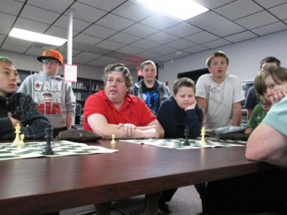 Chuck Mullen while still a teacher with students at chess tournament in 2014. [photo by Gary Meyer]