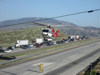 The LA County Fire Department medevac helicopter lifts off from I-5 south of Gorman. [photo by Gary Meyer]