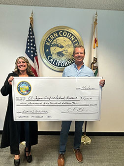 Parlier presents a check to Haflich