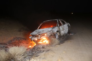 This car set ablaze off of Avenue B8 east of 125th Street was glowing like a woodstove. It could have caused a deadly wildfire. [Jeff Zimmerman photo]