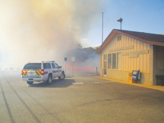 The flames raced through an oak grove then smaller trees before reaching the north edge of Lebec Post Office parking lot. [photo by Gary Meyer]