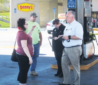 Flying J manager Chris Hert (right) took reports from customers who had purchased gasoline on the morning of June 8 from 7 to 9:30 a.m. [photo by Gary Meyer]