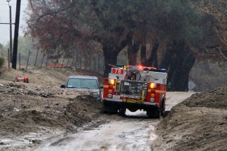 Mud and rock slides in the Power House burn area just south of the town of Lake Hughes on Lake Hughes Road. Los Angeles County Firefighters and Sheriff Search and Rescueare helping to remove vehicles trapped in the debris flow . Hillsides are starting to slide onto Lake Hughes Road and along Elizabeth Lake Road. [Jeff Zimmerman photos]