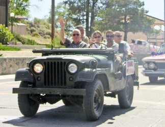Kern County Supervisor David Couch cruises through the parade in a WWII era Jeep. [photo by Gary Meyer]