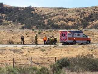 Rob Eubank shot this photo from an adjacent field of firefighters and ambulance personnel helping the driver.