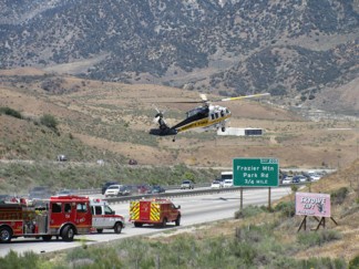 Los Angeles County Fire Department lands a helicopter on Interstate 5 at about 12:30 p.m. to transport a seriously-injured person from the scene of a rollover accident. [photo by Gary Meyer, The Mountain Enterprise]
