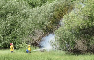 Kern County fire fighters knock down a small brush fire near Lebec Community Church on Friday, May 20. [photo by Gary Meyer, The Mountain Enterprise]