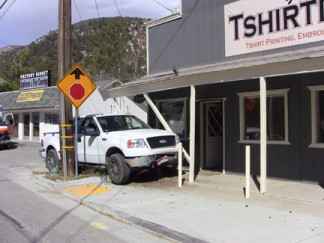 A white Ford pickup truck barely missed a telephone pole and a building at Mt. Pinos Way and Pomona Trail this morning. [photo by Gary Meyer]