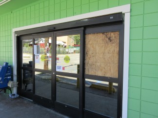 The Frazier Park Market had a plywood sheet over its broken window on Sunday morning, July 17. A thief or thieves were seen breaking into the store to allegedly steal beer. [Gary Meyer photo for The Mountain Enterprise]