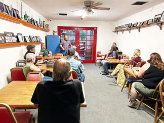 Supervisor candidate Kelly Carden meets with community members at Cave Man Cavey's Pizza