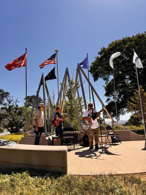 James Allison and Jacob Martinez accompany Andrew Reininger in a rendition of “This Land is Your Land”