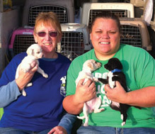 KCAS Rescue staff Angela and Deanna pose with puppies headed to Washington state [Margaret Kalar photos]