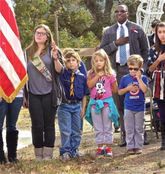 Saluting the flag during the singing of the Star Spangled Banner at the Veterans Day ceremony at Cody Prosser Veterans Memorial in Frazier Mountain Park, (l-r) Janice and Michael Winter, Gracie Rae and Dakota Durocher, Terrence Alexis and Sierra Tapia.