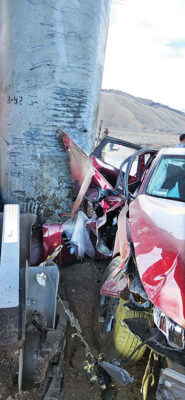 The crumpled Kia against the concrete pillar; below: firefighters help prepare the injured for a medevac flight to a Newhall area hospital.