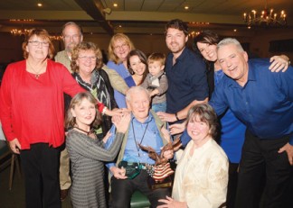 Merrill Baughman with award, surrounded by family and friends Feb. 21 [photo by KCSO]