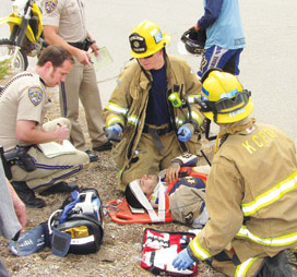A paramedic helps John Aguilar, Jr.  [Patric Hedlund photo]