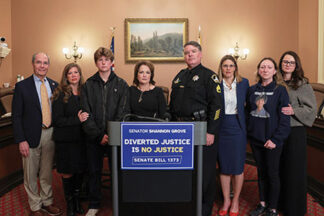 Grove with Christina and Robert Scrivner at a press conference