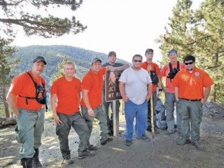 These members of the Southern Kern Search and Rescue unit took a rigorous night training hike on June 29, 2013. They are (l-r)  Steve Packard, David Atwell, Michael DeLeo, Cody Salyards, Scott Parker, Taylor Dubois, Doug Wilde and Mike Parker, Jr. Unit Captain Frank Heilman took the photo. This photo was taken at 8 a.m. at the Cerro Noroeste Peak trail head after completing an all-night training hike that left from the Mil Potrero “Y” at the base of Mount Pinos (and Mil Potrero Highway) at 7 p.m. June 28. See SKSAR recruitment ad on page 3. 
[photo by Unit Captain Frank Heilman]