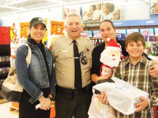 Out with his wife on a Shop with a Cop adventure in December of 2013, buying presents for a young man. [photo by Deputy David Lidgett]