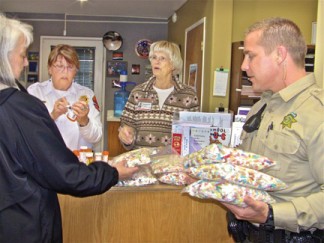 Kern County Sheriff’s Citizens Service Unit Lt. Prudy Benton and Captain Carole Trudeau with KCSO Deputy Ryan Brock as 25 pounds of  Drug Take Back medicines are packaged for disposal Saturday, April 26. [photo by Patric Hedlund]