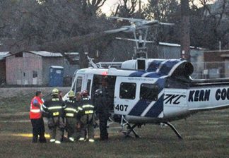 Firefighters and paramedics prepare to fly Thomas Roberts to Kern Medical Center. [photo by Gary Meyer, The Mountain Enterprise]