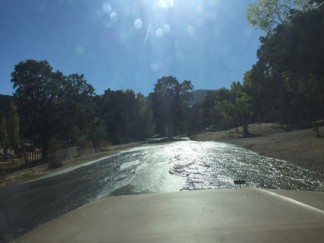 Water rushing down Lebec Oaks Road from Canyon Drive in Los Padres Estates at about 3:30 p.m. on Tuesday, Oct. 25. [photo by Dennis Penna]