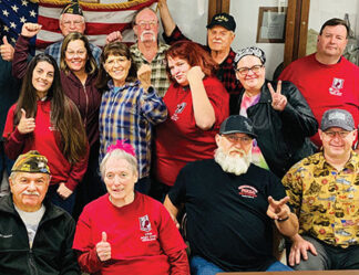 Above, center: Retired Auxiliary President Barbara Norcross in 2022 with VFW and Auxiliarly members celebrating their victory in saving Post 9791