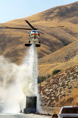 A Los Angeles County Fire Department helicopter drops water to help extinguish the big rig fire on I-5 northbound, south of Gorman, Wednesday, July 27. [Jeff Zimmerman photo]