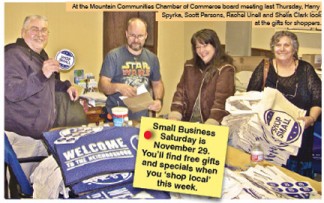 At the Mountain Communities Chamber of Commerce board meeting last Thursday, Harry Spyrka, Scott Parsons, Rachel Unell and Shelia Clark look at the gifts for shoppers. [photo by Patric Hedlund]