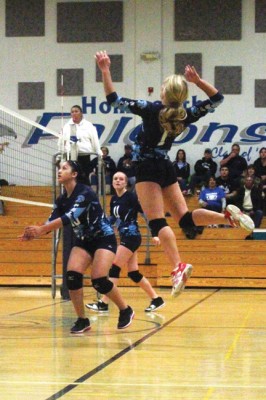 Rachel Rivette hangs in the air before slamming the ball down at the Bishop Knights. [photo by Cliff Coleman]